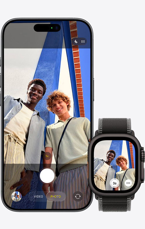 iPhone 17, front exterior, camera in use to capture group selfie, next to Apple Watch Ultra 3 with Camera Remote app open
